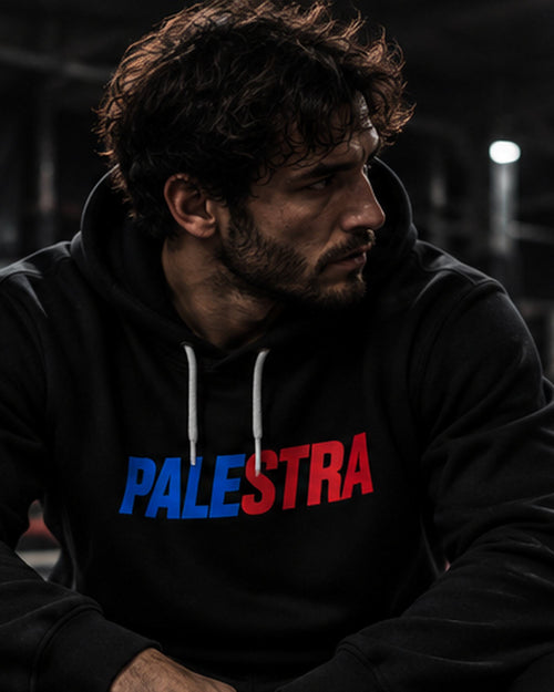 Athlete wearing a black PALESTRA hoodie